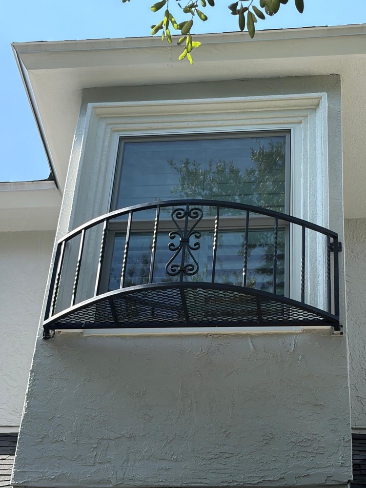 Close-up of a newly installed window with wrought iron balcony detail in Jacksonville, FL — Sunrise Exteriors